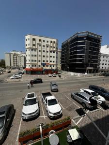 a parking lot with several cars parked in it at Alreef Hotel Suits in Muscat