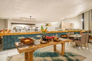 a kitchen with a table with food on it at Protea Hotel by Marriott Oudtshoorn Riempie Estate in Oudtshoorn