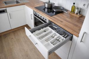 a kitchen with a stove with a pot on it at APSTAY central station I Self Check-in I Parking option in Graz +16 photos