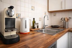 a kitchen counter with a mixer and a sink at APSTAY central station I Self Check-in I Parking option in Graz