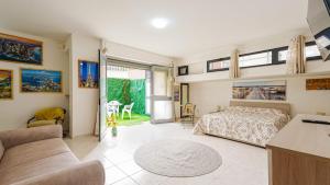 a bedroom with a bed and a living room at Villa Xenia in Pizzo