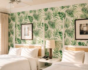 a bedroom with two beds and a tropical wallpaper at The Betsy Hotel, South Beach in Miami Beach +113 photos