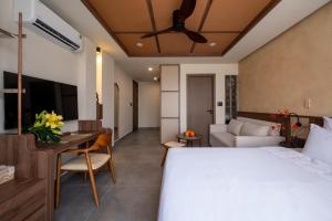 a bedroom with a bed and a table and a couch at REFUEL NEST Boutique Hotel in Danang +54 photos