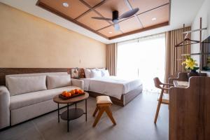 a hotel room with a bed and a couch at REFUEL NEST Boutique Hotel in Danang