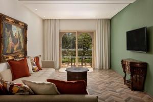 a living room with a couch and a table at Delta Hotels by Marriott Marrakech Eden Andalou in Marrakesh