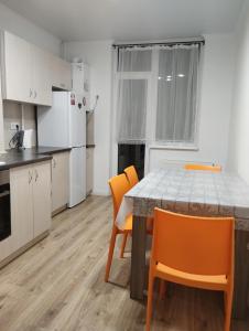 a kitchen and dining room with a table and chairs at Апартаменти ЖК Скеля in Yaremche