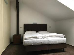 a bedroom with a large bed with white sheets at Penzión Karla Naj in Nitra +30 photos