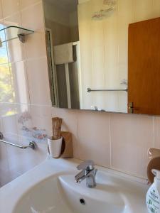 a bathroom with a sink and a mirror at La Villetta in Lacona +29 photos
