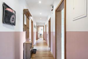 a hallway of a house with white walls and wooden floors at Ferienwohnung Heimelig im Bayerwald in Haidmühle