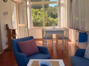 a living room with a table and chairs and a window at La Villetta in Lacona