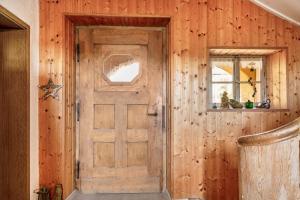 a door in a room with a wooden wall at Ferienwohnung Heimelig im Bayerwald in Haidmühle +22 photos