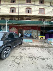 a car parked in front of a building at Hostel Inn in Andijan +9 photos