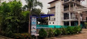 a building with a sign in front of it at RS Green Barathi in Kilinochchi