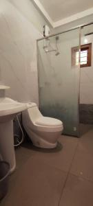 a bathroom with a shower and a toilet and a sink at RS Green Barathi in Kilinochchi