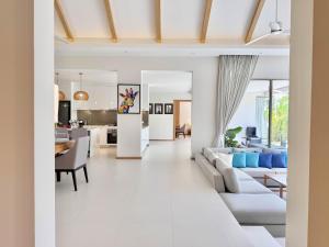 a living room with a couch and a table at Bali-Style 4 BR Private Pool Villa - Trichada in Phuket +112 photos