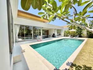 an image of a swimming pool in the backyard of a house at Bali-Style 4 BR Private Pool Villa - Trichada in Phuket