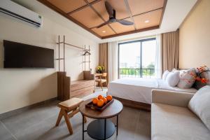 a hotel room with a bed and a couch at REFUEL NEST Boutique Hotel in Danang