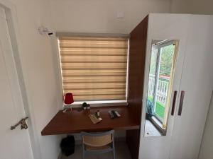 a room with a window with a desk and a mirror at Little Retreats in Nedumbassery +69 photos