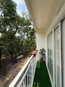 a balcony with a view of a yard at Little Retreats in Nedumbassery