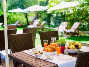 a table with a plate of food and drinks on it at Relax Houses in Ognyanovo
