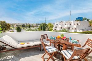 a patio with a table and chairs on a balcony at Clube Albufeira: 2BR Prime Holidays Retreat in Albufeira
