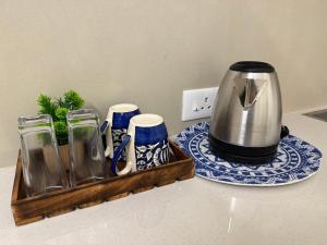 a toaster sitting on a counter next to a tray at Little Retreats in Nedumbassery