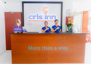 two women are standing behind a counter in a store at Cris Inn Tagum in Tagum