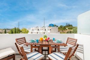 a wooden table with chairs and fruit on a balcony at Clube Albufeira: 2BR Prime Holidays Retreat in Albufeira +59 photos