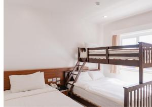 a bedroom with two bunk beds and a window at Cris Inn Tagum in Tagum +14 photos