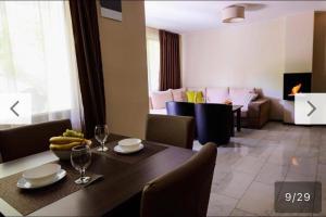 a dining room with a table and a living room at Relax Houses in Ognyanovo