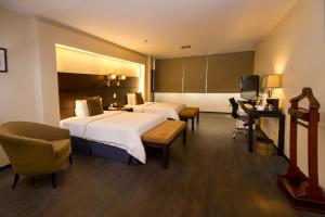Rúm í herbergi á Unipark by Oro Verde Hotels