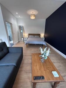 a living room with a couch and a coffee table at Sycamore Stay in Spalding