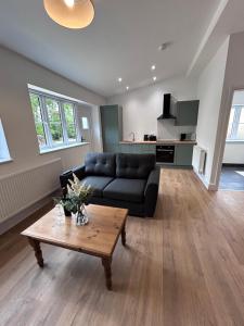 a living room with a couch and a coffee table at Sycamore Stay in Spalding