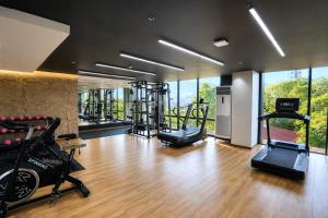 a gym with several exercise equipment in a room at oneTree Plaza Hotel Cebu in Cebu City