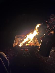 a fire pit with a person sitting next to it at かんぬしの宿 in Yamaguchi +11 photos