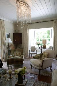 a living room with two chairs and a chandelier at Wyett House in Greytown