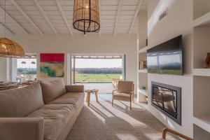 a living room with a couch and a fireplace at Casa Terracotta with Private Pool in Comporta +63 photos