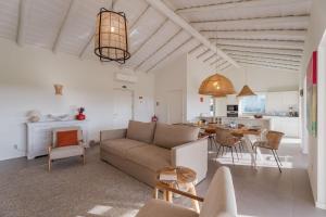 a living room with a couch and a table at Casa Terracotta with Private Pool in Comporta