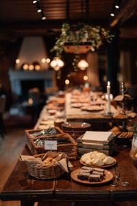 a long table with plates of food on it at Gammelgården in  Högfjället
