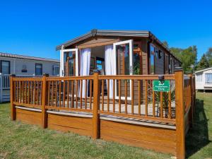 a large wooden gazebo with a fence at 25 Foxburrow Hang in Great Yarmouth
