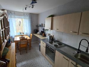 a kitchen with a sink and a stove top oven at Märchenwerkstatt in Netphen