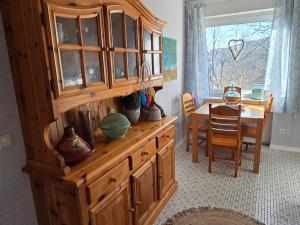 a kitchen with a wooden hutch and a dining room at Märchenwerkstatt in Netphen