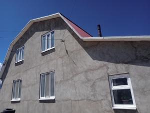 a building with three windows on the side of it at Тумар дом in Tamga