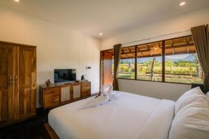 a bedroom with a large bed with a bird on it at Tegal Wangi Penebel in Penebel +62 photos