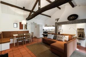 a living room and kitchen with a couch and a table at Eira Country House in Ponte de Lima