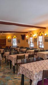 a dining room with tables and chairs and windows at Yakamoz Hotel Fethiye in Fethiye