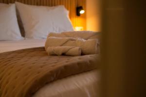 a pile of towels sitting on top of a bed at Jo's Apartment in Mytilene +42 photos