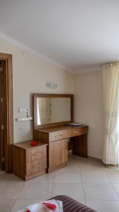 a bathroom with a large mirror and a dresser at Yakamoz Hotel Fethiye in Fethiye +70 photos