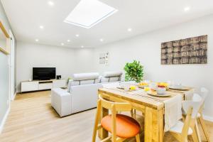 a living room with a table and a couch at Espinho Beach 4 Stays with Terrace in Espinho