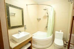 a bathroom with a sink and a toilet and a mirror at As-Salam Boutique Hotel in Bukhara +81 photos
